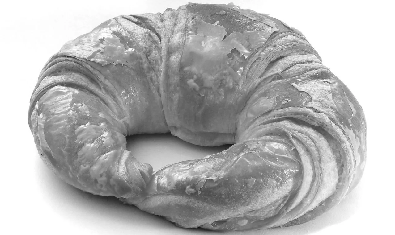 A croissant, a crescent-shaped French pastry made from laminated, yeast-leavened dough and butter. 