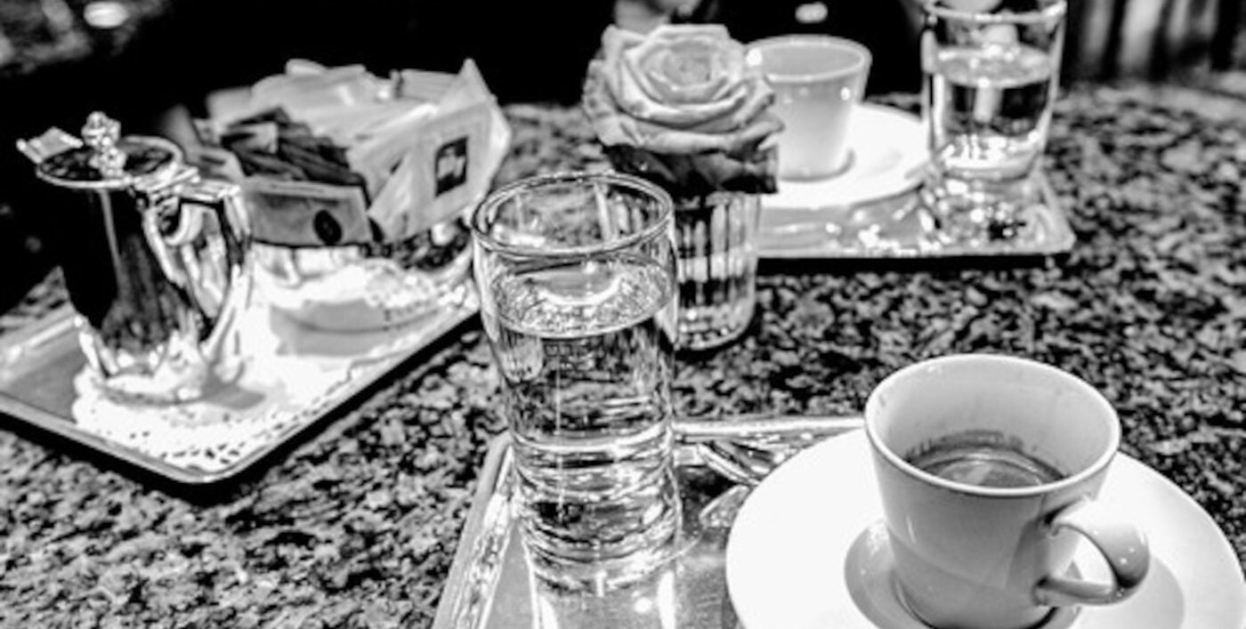 Espresso, a glass of water, sugar and milk.